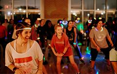 Zumba class dancing wearing glow necklaces